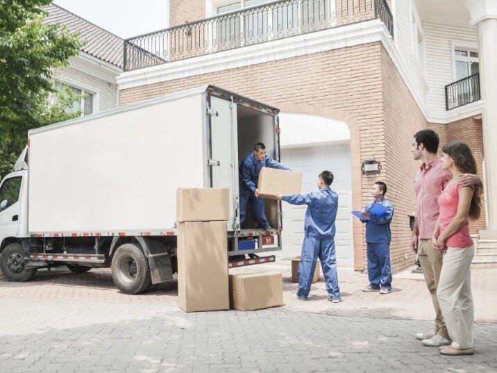 movers carefully loading furniture into a moving van in Armonk NY